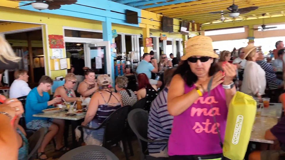 Festive restaurant interior near a lively tiki bar.